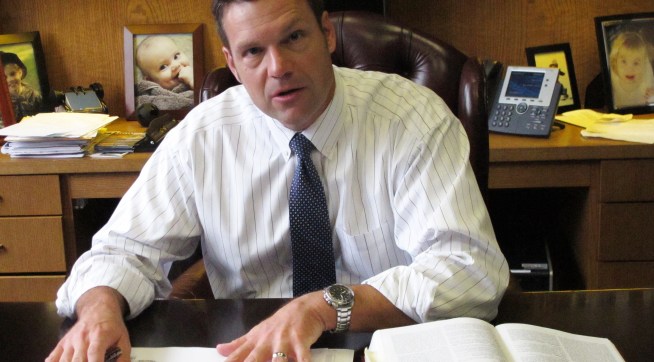 In this Friday, Sept. 12, 2014 photo, Kansas Secretary of State Kris Kobach discusses his office's legal research for an elections case before the state Supreme Court during an interview in his office in Topeka, Kan. Democrat Chad Taylor has petitioned the Supreme Court to remove his name from the ballot for the U.S. Senate after Kobach refused to do it. (AP Photo/John Hanna)