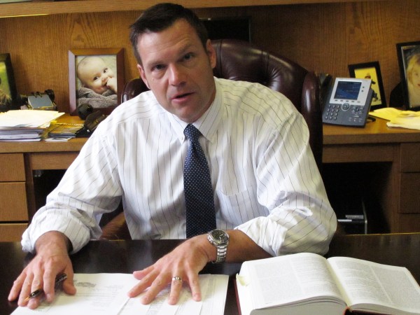 In this Friday, Sept. 12, 2014 photo, Kansas Secretary of State Kris Kobach discusses his office's legal research for an elections case before the state Supreme Court during an interview in his office in Topeka, Kan. Democrat Chad Taylor has petitioned the Supreme Court to remove his name from the ballot for the U.S. Senate after Kobach refused to do it. (AP Photo/John Hanna)