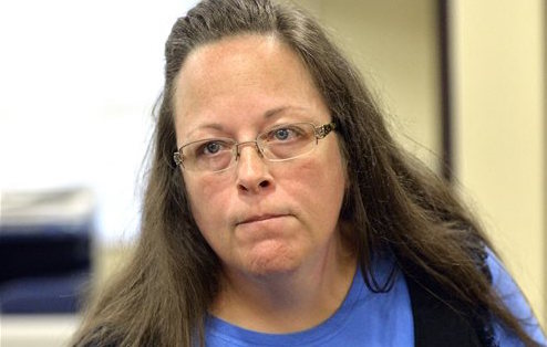 Rowan County Clerk Kim Davis listens to a customer following her office's refusal to issue marriage licenses at the Rowan County Courthouse in Morehead, Ky., Tuesday, Sept. 1, 2015. Although her appeal to the U.S. Supreme Court was denied, Davis still refuses to issue marriage licenses. (AP Photo/Timothy D. Easley)