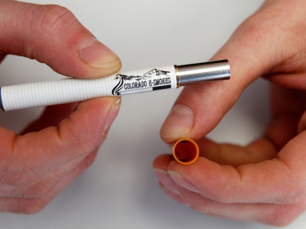 This photo taken on Wednesday, Mar. 2, 2011, shows XXXXXX as he demonstrates 
at an E-Smokes store in Aurora, Colo.  (AP Photo/Ed Andrieski)