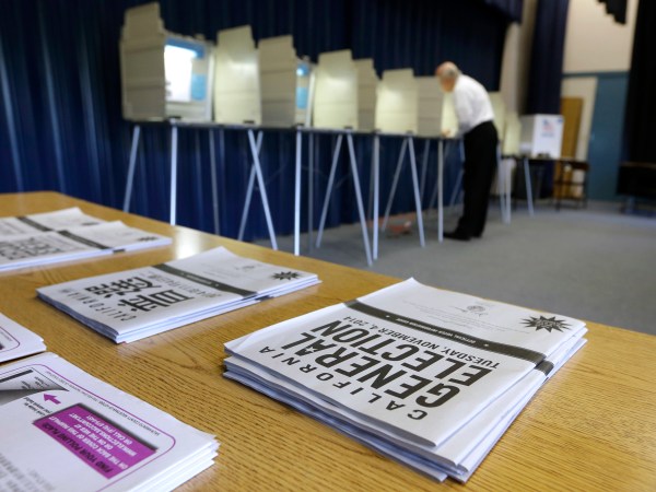 FILE - In this Nov. 4, 2014, file photo, a voter marks his ballot while voting in Elk Grove, Calif. Oregon is the first state to adopt the idea that it is the government's responsibility to register voters — a move that could increase the number of registered voters by 13 percent by the November election. California has approved similar legislation, and automatic registration bills have been introduced in more than a dozen other states. (AP Photo/Rich Pedroncelli, File)