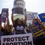 Pro-choice activists celebrate during a rally at the Supreme Court, Monday, June 27, 2016, in Washington. The Supreme Court struck down Texas' widely replicated regulation of abortion clinics Monday in the court's biggest abortion case in nearly a quarter century.The justices voted 5-3 in favor of Texas clinics that had argued the regulations were a thinly veiled attempt to make it harder for women to get an abortion in the nation's second-most populous state. (AP Photo/Evan Vucci)