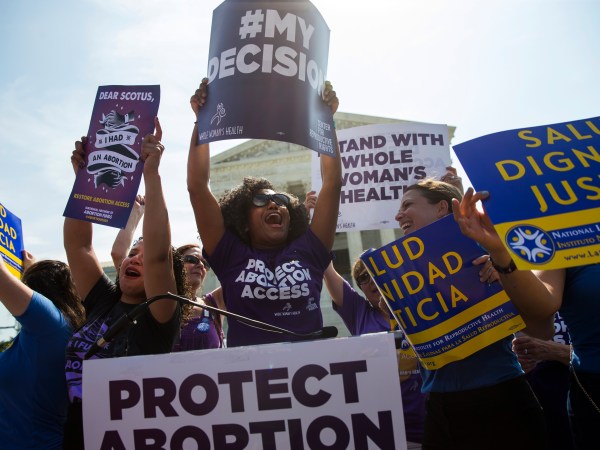 Pro-choice activists celebrate during a rally at the Supreme Court, Monday, June 27, 2016, in Washington. The Supreme Court struck down Texas' widely replicated regulation of abortion clinics Monday in the court's biggest abortion case in nearly a quarter century.The justices voted 5-3 in favor of Texas clinics that had argued the regulations were a thinly veiled attempt to make it harder for women to get an abortion in the nation's second-most populous state. (AP Photo/Evan Vucci)