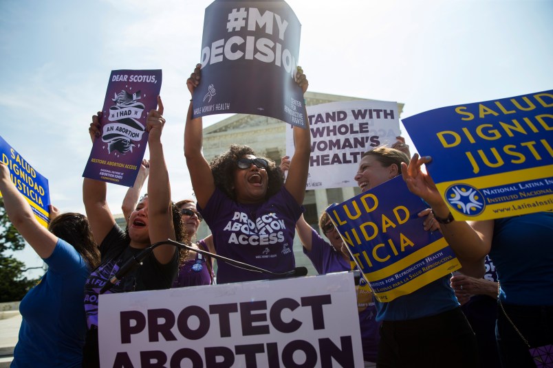 Pro-choice activists celebrate during a rally at the Supreme Court, Monday, June 27, 2016, in Washington. The Supreme Court struck down Texas' widely replicated regulation of abortion clinics Monday in the court's biggest abortion case in nearly a quarter century.The justices voted 5-3 in favor of Texas clinics that had argued the regulations were a thinly veiled attempt to make it harder for women to get an abortion in the nation's second-most populous state. (AP Photo/Evan Vucci)