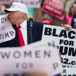 Republican presidential candidate Donald Trump kisses a "Women for Trump" sign during a campaign rally, Wednesday, Oct. 12, 2016, in Lakeland, Fla. (AP Photo/ Evan Vucci)