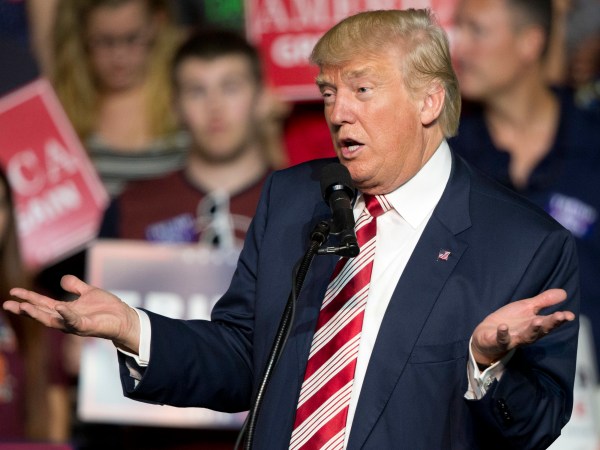 HOLD FOR STORY - FILE – In this Sept. 24, 2016, file photo, Republican presidential candidate Donald Trump gestures during a rally in Roanoke, Va. Countless former Democrats in Ohio's blue-collar Mahoning Valley are transferring their adoration for late U.S. Rep. James Traficant, D-Ohio, to Republican presidential nominee Donald Trump, while those who knew Traficant say similarities to Trump end at the populist bravado and outsized hair. (AP Photo/Steve Helber, File)