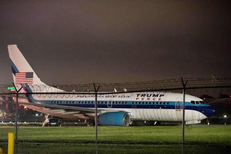 Republican presidential candidate Indiana Gov. Mike Pence's campaign airplane sits partially on the tarmac and the grass after sliding off the runway while landing at LaGuardia airport, Thursday, Oct. 27, 2016, in New York. (AP Photo/Mary Altaffer)