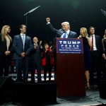 Republican presidential candidate Donald Trump pumps his fist as he arrives to speak during a campaign rally, Monday, Nov. 7, 2016, in Manchester, N.H. From left, Eric Trump, Vanessa Trump, Donald Trump Jr., Republican vice presidential candidate Gov. Mike Pence, R-Ind., Karen Pence, Trump, Ivanka Trump, Jared Kushner, and Tiffany Trump. (AP Photo/ Evan Vucci)
