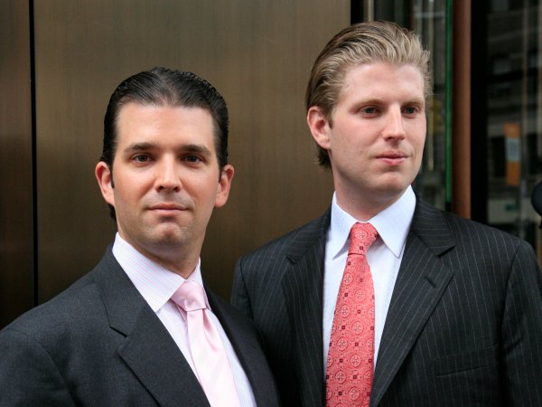 Donald Trump, Jr., left, and his brother Eric pose for photographers after attending the opening of the Trump SoHo New York, Friday, April 9, 2010. The 46 story hotel condominium has 391 units. (AP Photo/Mark Lennihan)
