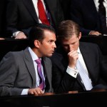 Donald Trump Jr., left, and his brother Eric talk while their father Republican Presidential Candidate Donald Trump speaks at the Republican National Convention, Thursday, July 21, 2016 in Cleveland. (AP Photo/Paul Sancya)