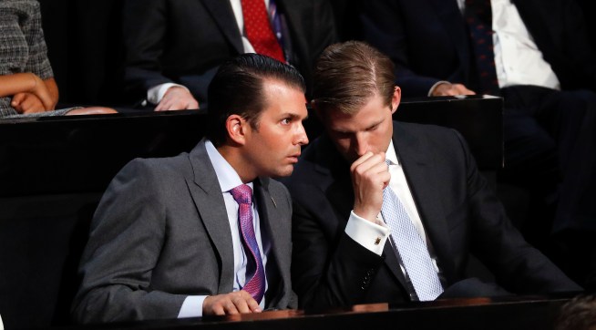 Donald Trump Jr., left, and his brother Eric talk while their father Republican Presidential Candidate Donald Trump speaks at the Republican National Convention, Thursday, July 21, 2016 in Cleveland. (AP Photo/Paul Sancya)
