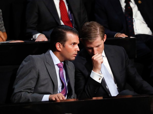 Donald Trump Jr., left, and his brother Eric talk while their father Republican Presidential Candidate Donald Trump speaks at the Republican National Convention, Thursday, July 21, 2016 in Cleveland. (AP Photo/Paul Sancya)
