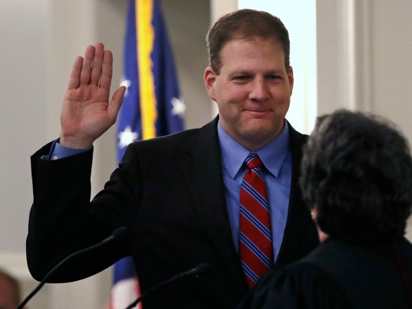 N.H. Gov. Chris Sununu raises his hand as he is sworn in at the State House in Concord, N.H., Thursday, Jan. 5, 2017. Sununu, the first Republican to hold the corner office in a dozen years, follows in the footsteps of his father, former N.H. Governor John H. Sununu. (AP Photo/Charles Krupa)