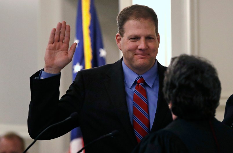 N.H. Gov. Chris Sununu raises his hand as he is sworn in at the State House in Concord, N.H., Thursday, Jan. 5, 2017. Sununu, the first Republican to hold the corner office in a dozen years, follows in the footsteps of his father, former N.H. Governor John H. Sununu. (AP Photo/Charles Krupa)