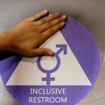 HOLD FOR STORY FILE - In this May 17, 2016 file photo, a new sticker is placed on the door at the ceremonial opening of a gender neutral bathroom at Nathan Hale High School in Seattle. Hundreds of parents across the country have called on President Donald Trump to embrace Obama-era protections for transgender students that call for letting them use school bathrooms in accordance with their gender identity. In a letter, sent to the president by the Human Rights Campaign late Tuesday, Feb. 14, 2017, more than 780 parents stressed that “all students deserve equal access to a safe, welcoming school and a high quality education no matter who they are.”  (AP Photo/Elaine Thompson, File)