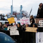Protesters rally in front of John F. Kennedy International Airport in New York, Sunday, Jan. 29, 2017. (AP Photo/Seth Wenig)