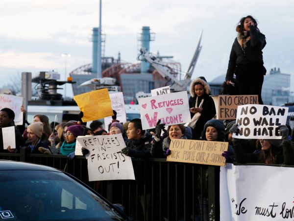 Protesters rally in front of John F. Kennedy International Airport in New York, Sunday, Jan. 29, 2017. (AP Photo/Seth Wenig)