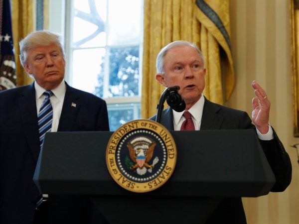 President Donald Trump watches as Vice President Mike Pence administers the oath of office to Attorney General Jeff Sessions, accompanied by his wife Mary, Thursday, Feb. 9, 2017, in the Oval Office of the White House in Washington. (AP Photo/Pablo Martinez Monsivais)