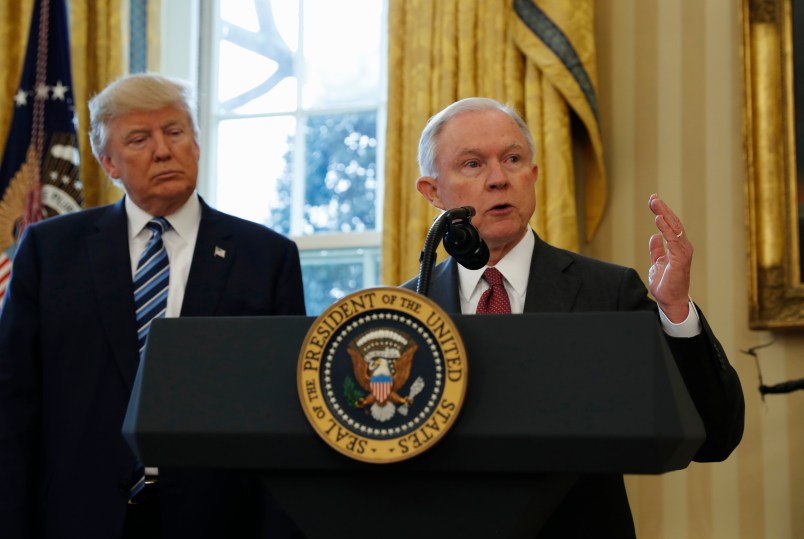 President Donald Trump watches as Vice President Mike Pence administers the oath of office to Attorney General Jeff Sessions, accompanied by his wife Mary, Thursday, Feb. 9, 2017, in the Oval Office of the White House in Washington. (AP Photo/Pablo Martinez Monsivais)