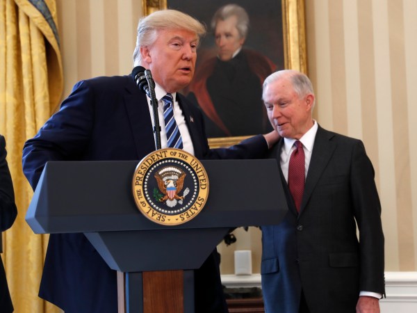President Donald Trump watches as Vice President Mike Pence administers the oath of office to Attorney General Jeff Sessions, accompanied by his wife Mary, Thursday, Feb. 9, 2017, in the Oval Office of the White House in Washington. (AP Photo/Pablo Martinez Monsivais)
