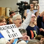 Cleone Hermsen, of Carroll, Iowa, expresses her criticism while listening to U.S. Sen. Joni Ernst, R-Iowa, during a veterans roundtable event at Maquoketa City Hall on Tuesday, Feb. 21, 2017, Maquoketa, Iowa.  The City Council chambers, where the event was taking place, was at capacity while more than 100 people were unable to enter. (AP/Telegraph Herald/Nicki Kohl)