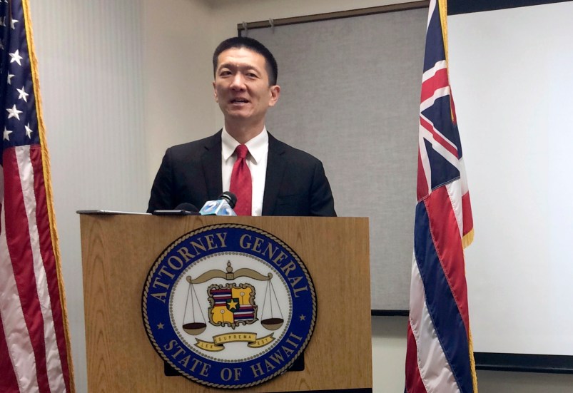 FILE - In this Feb. 3, 2017, file photo, Hawaii Attorney General Doug Chin speaks at a news conference in Honolulu announcing the state of Hawaii has filed a lawsuit challenging President Donald Trump's travel ban. Hawaii is planning to challenge Trump's revised travel ban. A motion filed in federal court on Tuesday, March 7, 2017, in Honolulu says the state wants to amend its existing lawsuit challenging Trump's previous order.  (AP Photo/Audrey McAvoy, File)