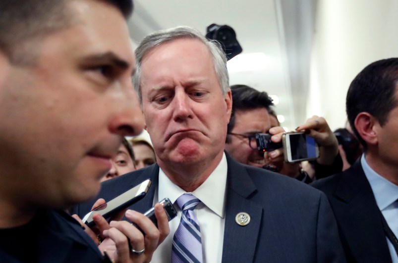 Rep. Mark Meadows, R-N.C., center, the chairman of the Freedom Caucus, reacts to a reporter's question, as he walks after a Freedom Caucus meeting on Capitol Hill, Thursday, March 23, 2017, in Washington. (AP Photo/Alex Brandon)
