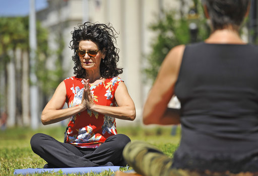 040717-County Court Judge Eleni Derke leads her yoga class on the lawn outside the Duval County Courthouse in Jacksonville, Florida Friday afternoon, April 7, 2017. Judge Derke who handles misdemeanor crimes and civil lawsuits is also a certified yoga instructor and the chairman of the Health Committee of the Jacksonville Bar Association. Judge Derke holds her Yoga on the Lawn class on the first Friday of every month, until the weather gets too hot. (AP Photo/Bob Self/Florida Times-Union)