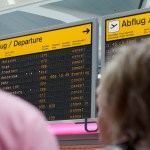 Passengers stand in front of the annunciator panel as all flights are canceled at Tegel Airport in Berlin, Germany, Wednesday, May 25, 2011. Hundreds of flights flights were canceled in Europe as winds blew the cloud of ash from the Grimsvotn volcano over parts of northern Europe. Experts say that particles in the ash could stall jet engines and sandblast planes' windows. (AP Photo/Gero Breloer)