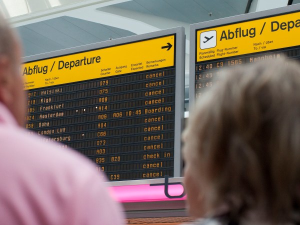 Passengers stand in front of the annunciator panel as all flights are canceled at Tegel Airport in Berlin, Germany, Wednesday, May 25, 2011. Hundreds of flights flights were canceled in Europe as winds blew the cloud of ash from the Grimsvotn volcano over parts of northern Europe. Experts say that particles in the ash could stall jet engines and sandblast planes' windows. (AP Photo/Gero Breloer)