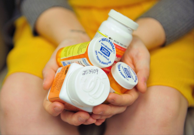 Heidi Wyandt, 27 holds a handful of her medication at the Altoona Center for Clinical Research where she receives experimental non-opioid pain medication for chronic back pain related to a work related injury she received in 2014 on Wednesday, March 29, 2017 in Altoona, PA. (AP Photo/Chris Post)