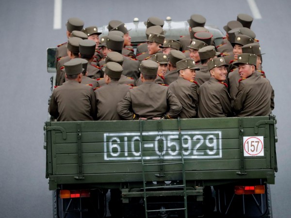 North Korean sit at the back of a truck as it drives along Mirae Scientists Street on Wednesday, April 19, 2017, in Pyongyang, North Korea which just celebrated its late leader Kim Il Sung's 105th birth anniversary with a military parade. (AP Photo/Wong Maye-E)