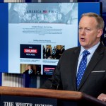 A new website that the White House has launched on President Donald Trump's first 100 days is displayed in front of White House press secretary Sean Spicer as he speaks to the media during the daily press briefing at the White House, Tuesday, April 25, 2017, in Washington. (AP Photo/Andrew Harnik)