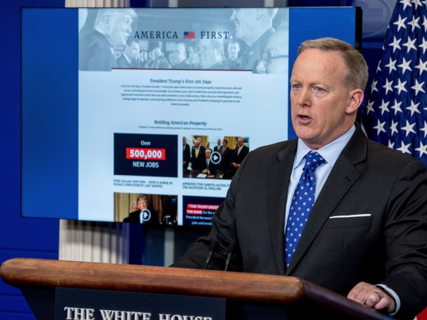 A new website that the White House has launched on President Donald Trump's first 100 days is displayed in front of White House press secretary Sean Spicer as he speaks to the media during the daily press briefing at the White House, Tuesday, April 25, 2017, in Washington. (AP Photo/Andrew Harnik)