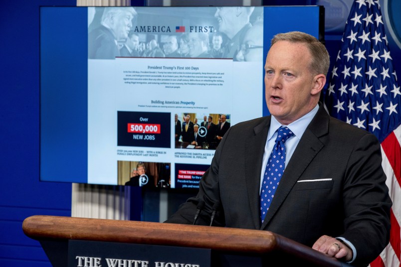 A new website that the White House has launched on President Donald Trump's first 100 days is displayed in front of White House press secretary Sean Spicer as he speaks to the media during the daily press briefing at the White House, Tuesday, April 25, 2017, in Washington. (AP Photo/Andrew Harnik)