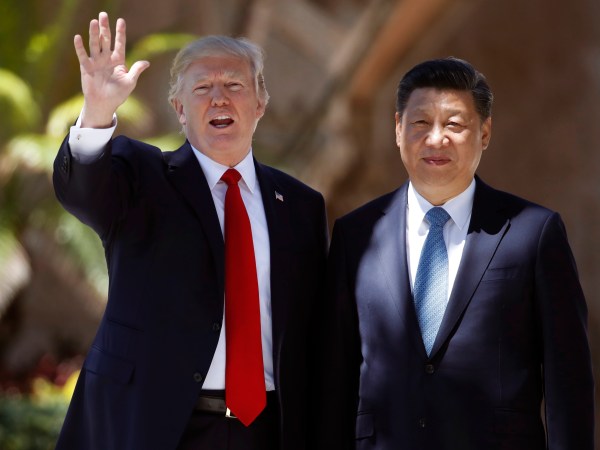 President Donald Trump and Chinese President Xi Jinping pause for photographs at Mar-a-Lago, Friday, April 7, 2017, in Palm Beach, Fla. Trump was meeting again with his Chinese counterpart Friday, with U.S. missile strikes on Syria adding weight to his threat to act unilaterally against the nuclear weapons program of China's ally, North Korea. (AP Photo/Alex Brandon)