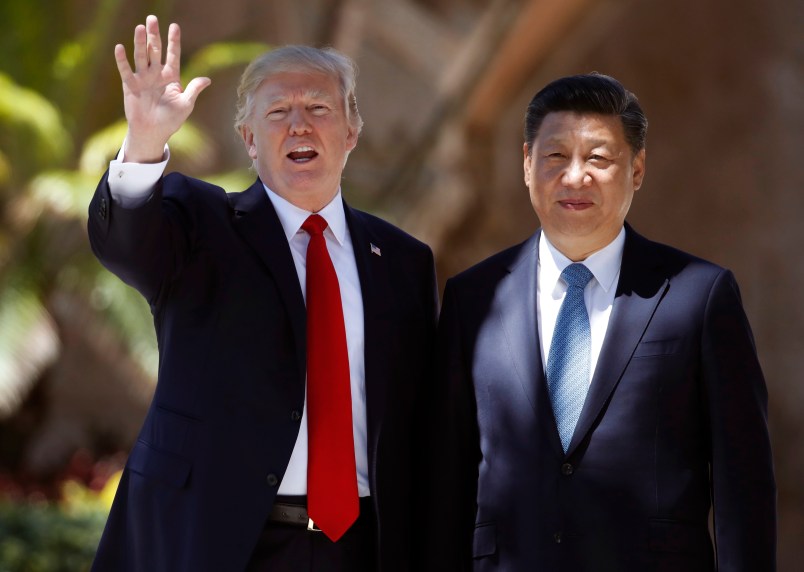 President Donald Trump and Chinese President Xi Jinping pause for photographs at Mar-a-Lago, Friday, April 7, 2017, in Palm Beach, Fla. Trump was meeting again with his Chinese counterpart Friday, with U.S. missile strikes on Syria adding weight to his threat to act unilaterally against the nuclear weapons program of China's ally, North Korea. (AP Photo/Alex Brandon)