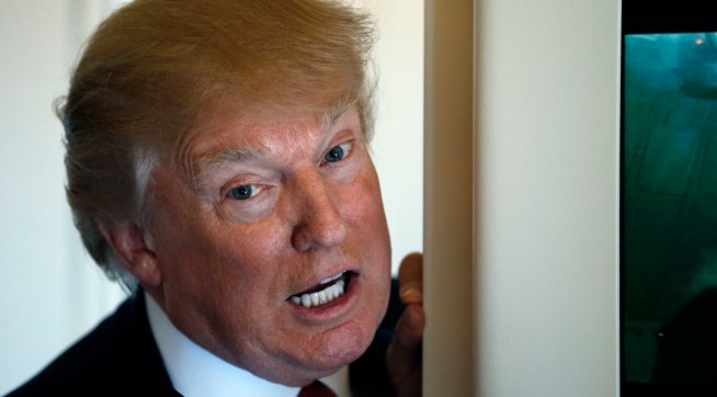 President Donald Trump speaks with reporters on Air Force One while in flight from Andrews Air Force Base, Md., to Palm Beach International Airport, Fla., Thursday, April 6, 2017. (AP Photo/Alex Brandon)