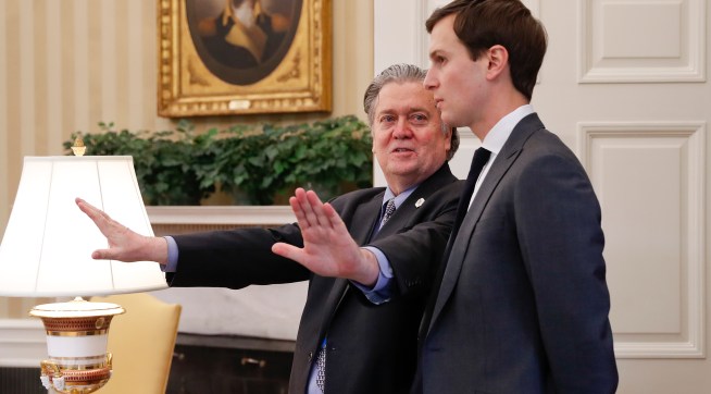 Counselor to the President of the United States, Steve Bannon, left, talks with White House senior advisers Jared Kushner, right, in the Oval Office of the White House in Washington, Friday, Feb. 3, 2017. (AP Photo/Pablo Martinez Monsivais)