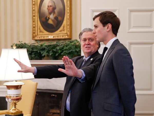Counselor to the President of the United States, Steve Bannon, left, talks with White House senior advisers Jared Kushner, right, in the Oval Office of the White House in Washington, Friday, Feb. 3, 2017. (AP Photo/Pablo Martinez Monsivais)