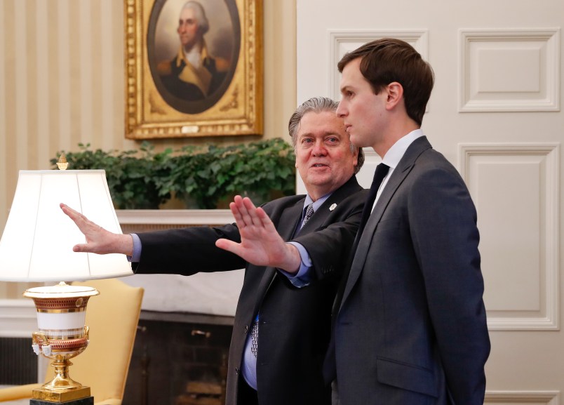 Counselor to the President of the United States, Steve Bannon, left, talks with White House senior advisers Jared Kushner, right, in the Oval Office of the White House in Washington, Friday, Feb. 3, 2017. (AP Photo/Pablo Martinez Monsivais)