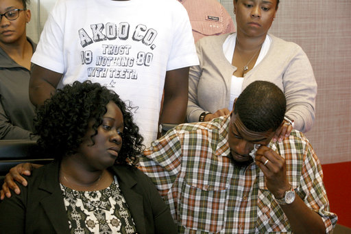 Odell Edwards wipes away tears as he sits with his wife, Charmaine Edwards, listenintg to their attorney Lee Merritt talking about the death of their son, Jordan Edwards, in a police shooting Saturday in Balch Springs, Texas in Merritt's law office in Dallas Monday, May 1, 2017.
