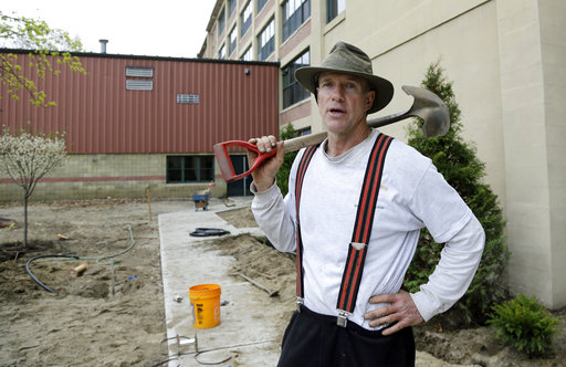 HOLD FOR STORY MOVING THURSDAYIn this April 25, 2017 photo, Stephen Faulkner, owner of Faulkner’s Landscaping & Nursery, holds a shovel at a landscape project in Manchester, N.H. New England businesses say they don't have enough workers for the season because of a cap on temporary worker visas. They're pushing for Congress to allow workers who used a visa previously to return, without counting toward the cap. But they're worried that the president's mantra of "buy American, hire American" isn't helping. (AP Photo/Elise Amendola)