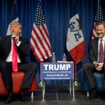 Jerry Falwell Jr., president of Liberty University, smiles as he listens to Republican presidential candidate Donald Trump, left, at a rally Sunday, Jan. 31, 2016, in Council Bluffs, Iowa. (AP Photo/Jae C. Hong)