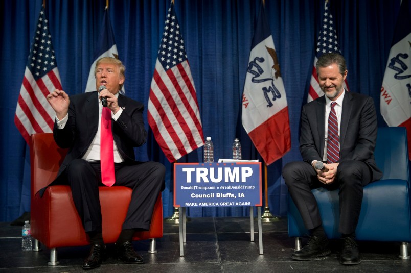 Jerry Falwell Jr., president of Liberty University, smiles as he listens to Republican presidential candidate Donald Trump, left, at a rally Sunday, Jan. 31, 2016, in Council Bluffs, Iowa. (AP Photo/Jae C. Hong)
