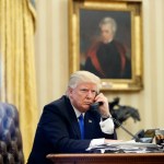 President Donald Trump speaks on the phone with Prime Minister of Australia Malcolm Turnbull in the Oval Office of the White House, Saturday, Jan. 28, 2017 in Washington. (AP Photo/Alex Brandon)