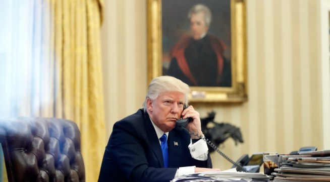 President Donald Trump speaks on the phone with Prime Minister of Australia Malcolm Turnbull in the Oval Office of the White House, Saturday, Jan. 28, 2017 in Washington. (AP Photo/Alex Brandon)