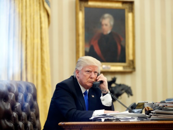 President Donald Trump speaks on the phone with Prime Minister of Australia Malcolm Turnbull in the Oval Office of the White House, Saturday, Jan. 28, 2017 in Washington. (AP Photo/Alex Brandon)