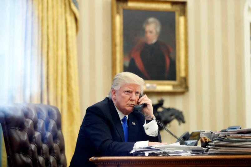 President Donald Trump speaks on the phone with Prime Minister of Australia Malcolm Turnbull in the Oval Office of the White House, Saturday, Jan. 28, 2017 in Washington. (AP Photo/Alex Brandon)
