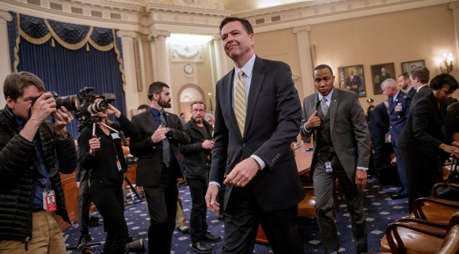 FBI Director James Comey takes a break after three hours of testifying as the House Permanent Select Committee on Intelligence holds its first public hearing on allegations of Russian interference in the 2016 U.S. presidential election and the murky web of contacts between President Donald Trump's campaign and Russia, on Capitol Hill in Washington, Monday, March 20, 2017. (AP Photo/J. Scott Applewhite)